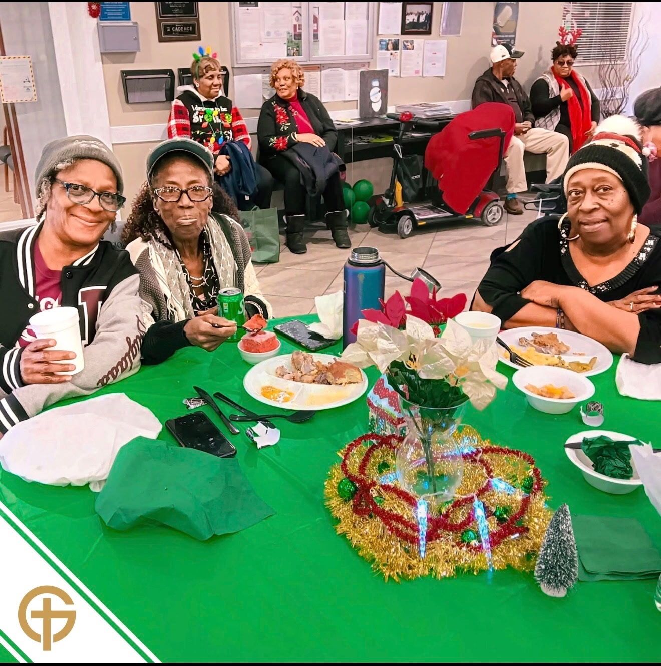 Senior residents smiling together at a Golden Cross holiday luncheon